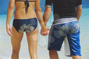 Royalty Free Photo of a Couple at the Beach Holding Hands