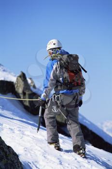 Royalty Free Photo of a Guy Going Up a Mountain