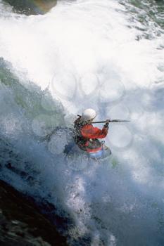 Royalty Free Photo of a Kayaker Going Over a Waterfall Into Rapids