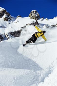 Royalty Free Photo of a Snowboarder Coming Down a Hill