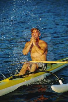 Royalty Free Photo of a Kayaker Splashing His Face