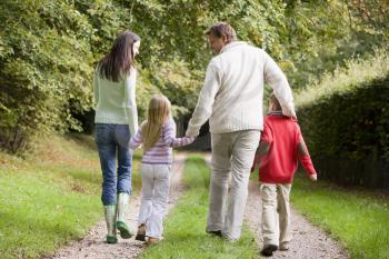 Royalty Free Photo of a Family Walking on a Trail From the Back