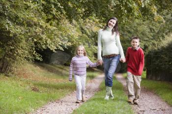 Royalty Free Photo of a Mother and Children on a Path