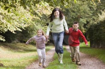 Royalty Free Photo of a Woman Running With Her Children