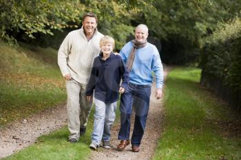 Royalty Free Photo of a Grandfather, Father and Son Walking on a Trail
