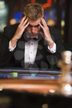 Royalty Free Photo of a Man Losing at a Casino