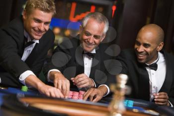 Royalty Free Photo of Three Men Playing Roulette