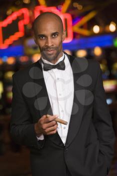Royalty Free Photo of a Man in a Casino Smoking a Cigar