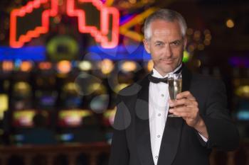 Royalty Free Photo of a Man in a Casino With a Champagne Flute