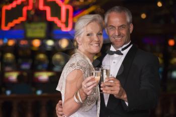 Royalty Free Photo of a Couple Holding Champagne in a Casino