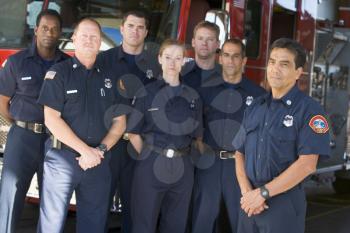 Royalty Free Photo of a Firefighting Team Beside the Truck