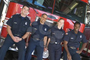 Royalty Free Photo of Firefighters Leaning on a Truck