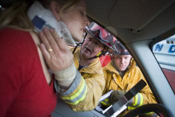 Royalty Free Photo of Firefighters Helping a Driver