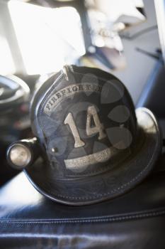 Royalty Free Photo of a Firefighter's Helmet on the Firetruck's Seat
