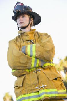 Royalty Free Photo of a Firefighter Standing Outdoors
