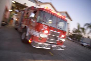 Royalty Free Photo of a Firetruck Leaving the Firehall