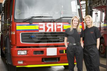 Royalty Free Photo of Two Female Firefighters in Front of the Truck