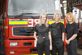 Royalty Free Photo of Three Female Firefighters in Front of the Truck