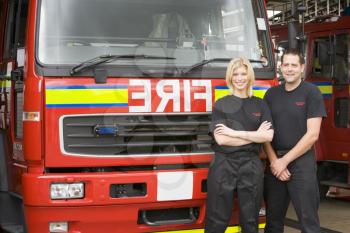 Royalty Free Photo of Two Firefighters in Front of the Truck