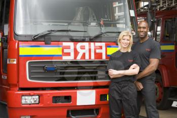 Royalty Free Photo of Two Firefighters in Front of the Truck