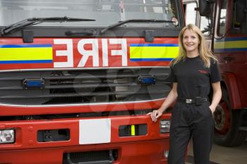 Royalty Free Photo of a Female Firefighter in Front of the Truck