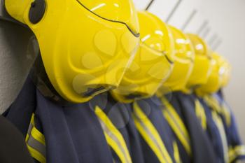 Royalty Free Photo of Firefighting Suits Hanging in a Row