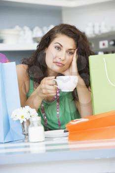 Royalty Free Photo of a Woman Taking a Break From Shopping