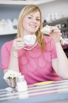 Royalty Free Photo of a Woman Eating a Sweet Treat