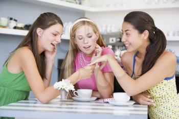 Royalty Free Photo of a Young Woman Showing Her Friends Her Engagement Ring