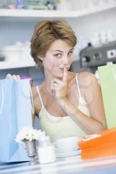 Royalty Free Photo of a Young Woman Taking a Break From Shopping