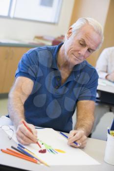 Royalty Free Photo of a Male Student Drawing Pictures