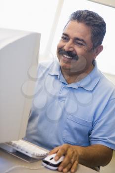 Royalty Free Photo of a Smiling Man at a Computer