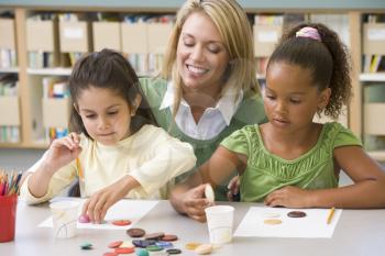 Royalty Free Photo of Two Students in Art Class With Their Teacher