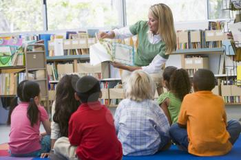 Royalty Free Photo of a Teacher Reading to Her Class