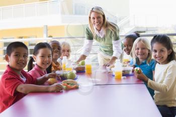 Royalty Free Photo of a Teacher Leaning on a Table With Her Students at Lunch
