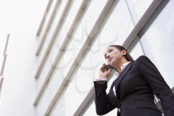 Royalty Free Photo of a Woman Outside a Building With a Cellphone