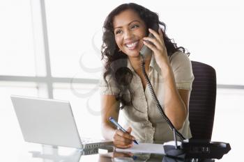 Royalty Free Photo of a Woman in an Office on the Phone