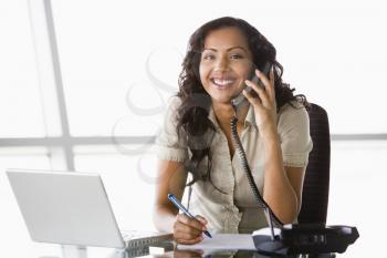 Royalty Free Photo of a Woman in an Office on a Telephone