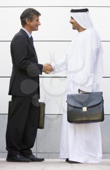 Royalty Free Photo of a Two Men of Different Cultures Shaking Hands