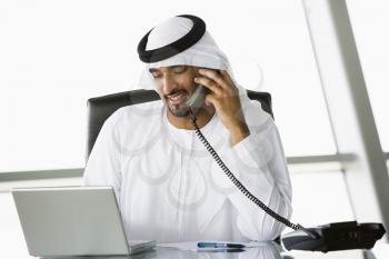 Royalty Free Photo of an Eastern Man on the Phone in His Office
