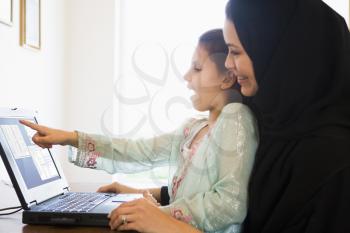 Royalty Free Photo of a Woman With Her Daughter at a Laptop
