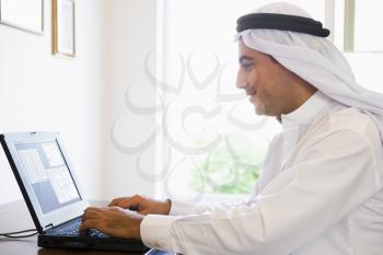 Royalty Free Photo of a Man in an Office With a Laptop