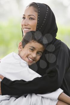 Royalty Free Photo of a Mother Hugging Her Son