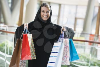 Royalty Free Photo of a Woman Showing Her Purchases at the Mall