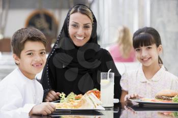 Royalty Free Photo of a Mother and Children Eating