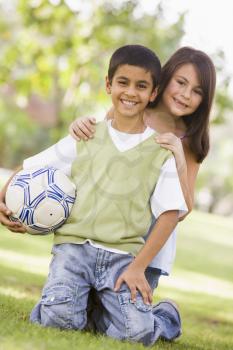 Royalty Free Photo of a Boy and Girl With a Soccer Ball