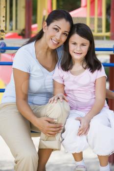 Royalty Free Photo of a Mother and Daughter on Playground Equipment