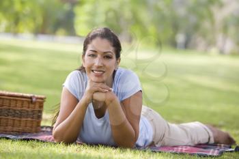 Royalty Free Photo of a Woman Lying at a Park