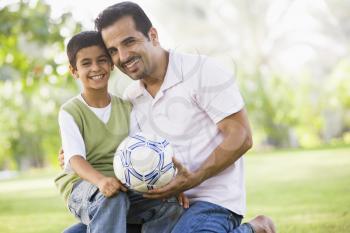 Royalty Free Photo of a Father and Son With a Soccer Ball