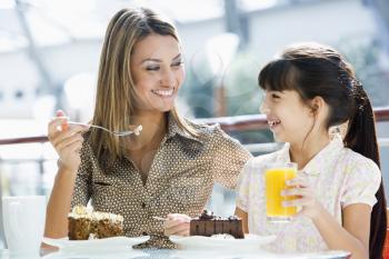 Royalty Free Photo of a Mother and Daughter Eating Dessert